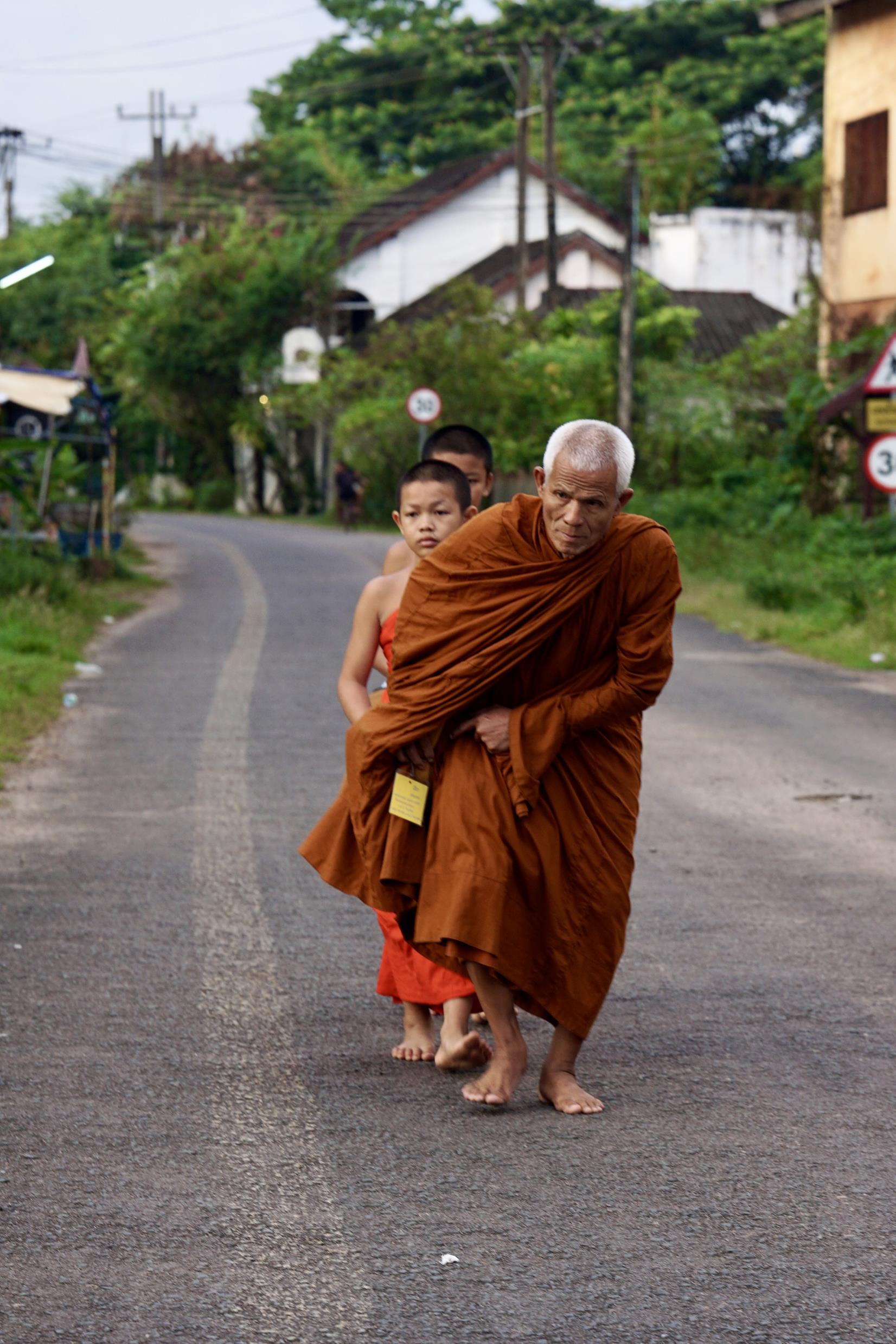 Almsgiving in champasak street with monks
